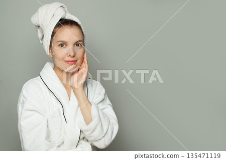 Attractive young woman with moisturizing, rejuvenating white fabric sheet mask Attractive young woman with moisturizing, rejuvenating white fabric sheet mask 135471119