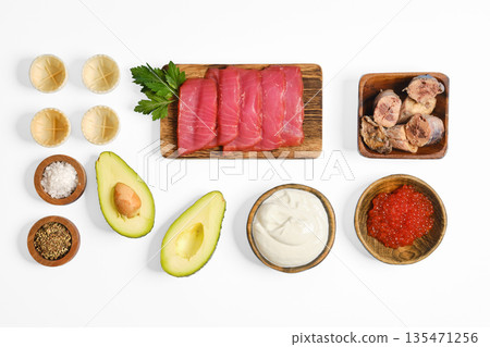 Fresh ingredients arranged for preparing a tuna tartare dish in a modern kitchen setting Fresh ingredients arranged for preparing a tuna tartare dish in a modern kitchen setting 135471256