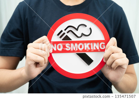 Male holding a no smoking sign. Male holding a no smoking sign. 135471507