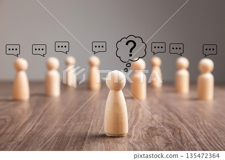 Wooden peg doll with question mark speech bubble 135472364