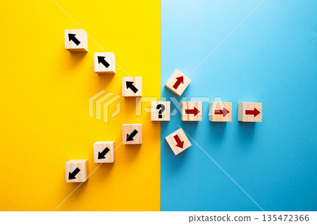 Wooden cubes with arrows showing decision uncertainty and different directions 135472366