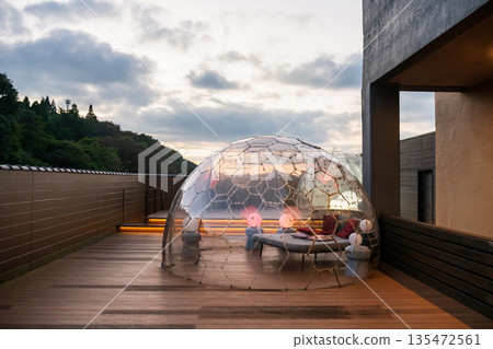 Transparent plastic igloo dome tent on hotel rooftop at sunset, Kumamoto 135472561