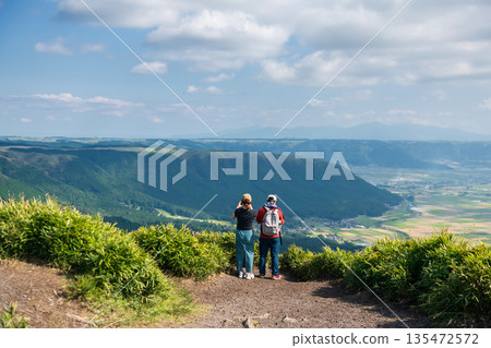 couple view and photograph at Daikanbo observatory summit, Kumamoto 135472572