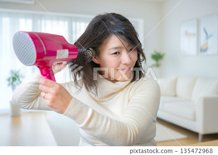 一個女人用吹風機 一個女人用吹風機 135472968