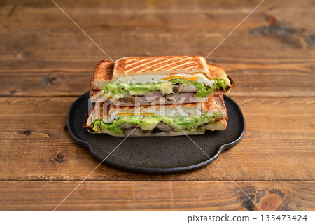 Broad bean, cheese and roasted pork hot sandwich Broad bean, cheese and roasted pork hot sandwich 135473424