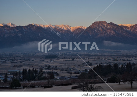 The Northern Alps dyed crimson red by the morning glow The Northern Alps dyed crimson red by the morning glow 135473591