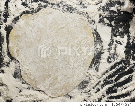Adventurous Home Chef Prepares Fresh Dough On Floured Surface For Baking Adventurous Home Chef Prepares Fresh Dough On Floured Surface For Baking 135474584