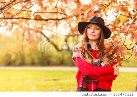 Woman standing by the tree. Woman standing by the tree. 135475181