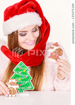 Woman santa claus hat with gingerbread cookies. Christmas Woman santa claus hat with gingerbread cookies. Christmas 135475194