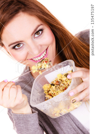 Woman eat oatmeal with dry fruits. Dieting 135475197
