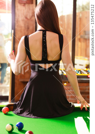 Young woman posing having fun with billiard. Young woman posing having fun with billiard. 135475212