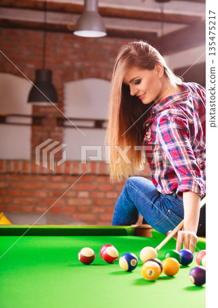 Young woman having fun with billiard. Young woman having fun with billiard. 135475217