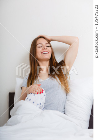Girl yawning in bed. 135475222