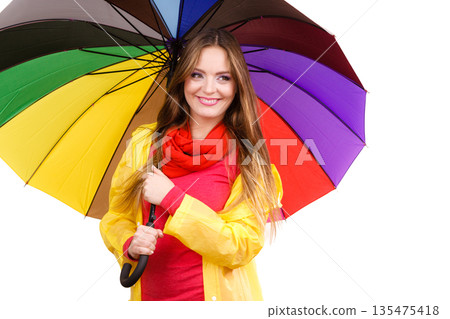 Woman in rainproof coat under umbrella Woman in rainproof coat under umbrella 135475418