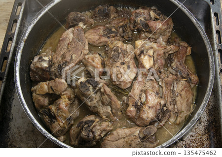 rustic roasted lamb pieces in pan rustic roasted lamb pieces in pan 135475462