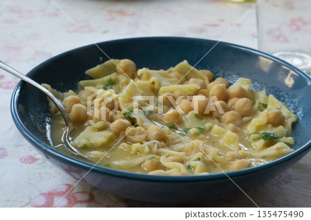 pasta with chickpeas in blue bowl for a healthy mediterranean meal on table pasta with chickpeas in blue bowl for a healthy mediterranean meal on table 135475490