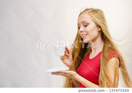 Blonde girl with coffee cup Blonde girl with coffee cup 135475569