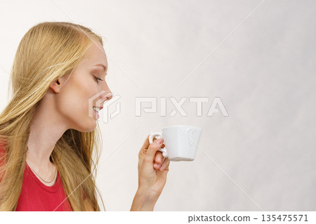 Blonde girl with coffee cup Blonde girl with coffee cup 135475571