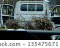 A light truck transporting pruned branches 135475671