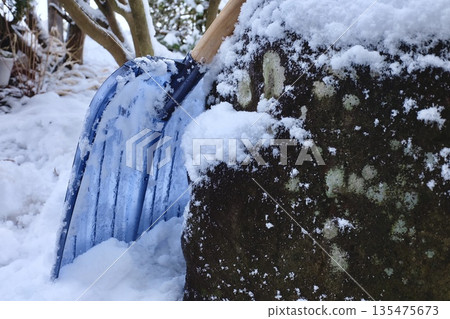 Garden stones and a blue snow shovel Garden stones and a blue snow shovel 135475673