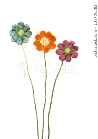 Three flowers from felted wool on a white background Three flowers from felted wool on a white background 135476382