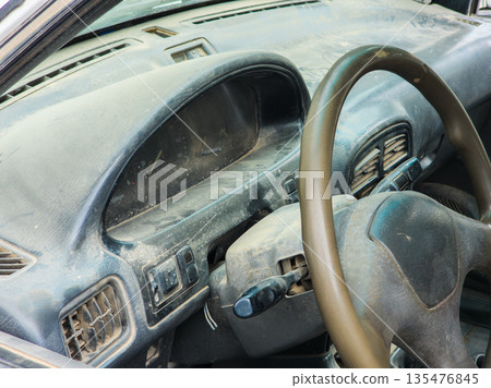 Abandoned car covered in dust in indoor setting Abandoned car covered in dust in indoor setting 135476845