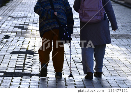 Yokohama cityscape in Japan: steps... Aging society: Elderly woman with a cane can't lift her legs... Dangers lurk even on the sidewalk... Yokohama cityscape in Japan: steps... Aging society: Elderly woman with a cane can't lift her legs... Dangers lurk even on the sidewalk... 135477151