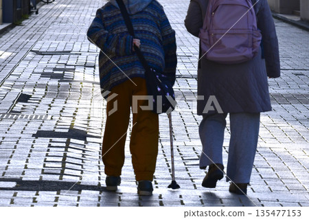 Yokohama cityscape in Japan: steps... Aging society: Elderly woman with a cane can't lift her legs... Dangers lurk even on the sidewalk... 135477153