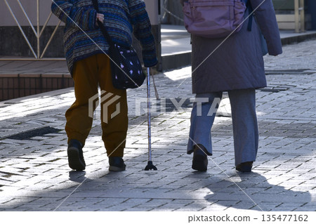 Yokohama cityscape in Japan: steps... Aging society: Elderly woman with a cane can't lift her legs... Dangers lurk even on the sidewalk... Yokohama cityscape in Japan: steps... Aging society: Elderly woman with a cane can't lift her legs... Dangers lurk even on the sidewalk... 135477162