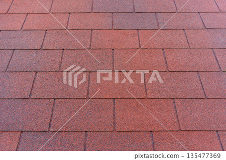 Red Bituminous Roof Shingle Texture Background with Granular Surface 135477369