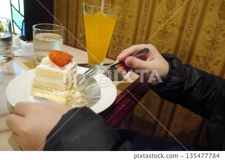 Person eating cake set (hand) Person eating cake set (hand) 135477784