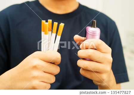 Man holding electronic cigarettes, no smoking. Man holding electronic cigarettes, no smoking. 135477827