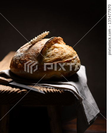 Appetizing sourdough bread with cracked crust Appetizing sourdough bread with cracked crust 135477970