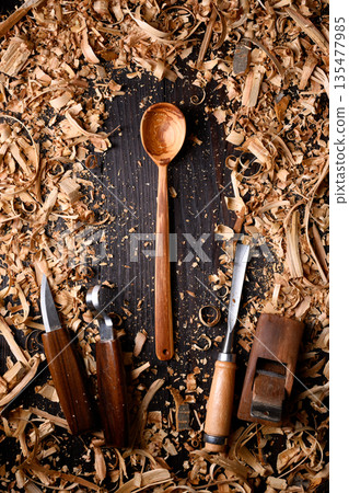 Handcrafted wooden spoon with heap of wooden filings Handcrafted wooden spoon with heap of wooden filings 135477985