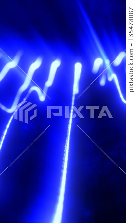 Abstract glowing blue light streaks forming dynamic flowing patterns on a dark background 135478087