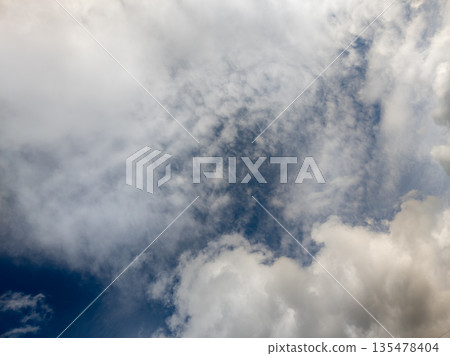 Fluffy white clouds in a serene blue sky during daytime Fluffy white clouds in a serene blue sky during daytime 135478404