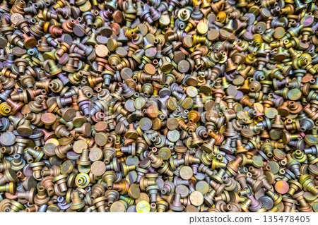 Pile of iridescent Cadmium chromate plated parts Pile of iridescent Cadmium chromate plated parts 135478405