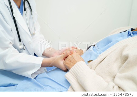 Asian doctor checking and treat elderly woman patient health in hospital. Asian doctor checking and treat elderly woman patient health in hospital. 135478573