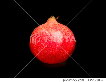 Pomegranate on a black background. 135479032