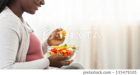 Black Pregnant Lady Enjoying Fresh Vegetable Salat While Sitting On Bed, Enjoying Eating Healthy Nutrition During Pregnancy, Holding Bowl With Organic Meal, Cropped Image, Side View, Panorama Black Pregnant Lady Enjoying Fresh Vegetable Salat While Sitting On Bed, Enjoying Eating Healthy Nutrition During Pregnancy, Holding Bowl With Organic Meal, Cropped Image, Side View, Panorama 135479105