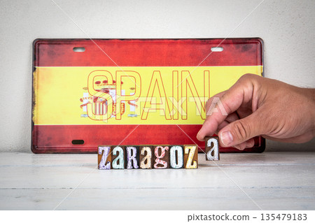 Hand Arranging Zaragoza Letters In Front Of Spain Sign On Wooden Surface Hand Arranging Zaragoza Letters In Front Of Spain Sign On Wooden Surface 135479183