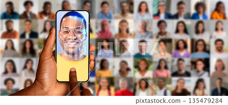 A user scans their face on a smartphone screen, utilizing facial recognition technology. 135479284