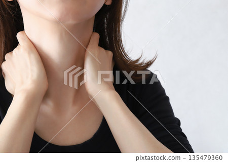 Woman holding her neck, stiff shoulders Woman holding her neck, stiff shoulders 135479360