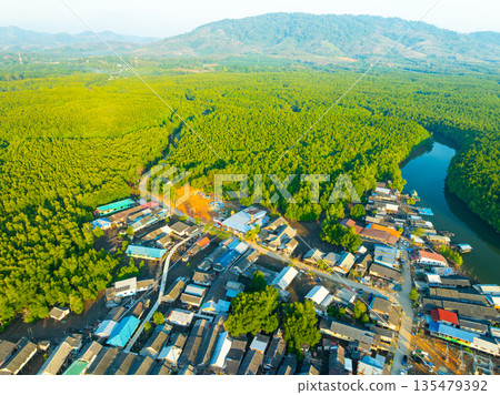 Aerial view top view of the fisherman village with fishing boats and house roof at the pier in Phangnga Thailand, Panorama high angle view 135479392