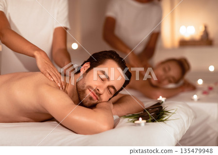 Relaxed Couple Enjoying Massage And Herbal Aromatherapy Lying In Luxury Spa Center Indoor. Body Care And Beauty Treatment, Wellness And Relaxation Concept. Selective Focus 135479948