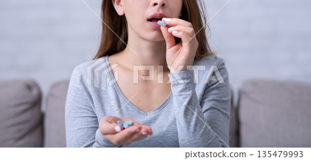 Desperate young woman suffering from depression, ovrdosing on pills, committing suicide at home. Stressed millennial lady having nervous breakdown, emotional burnout, going through personal crisis 135479993