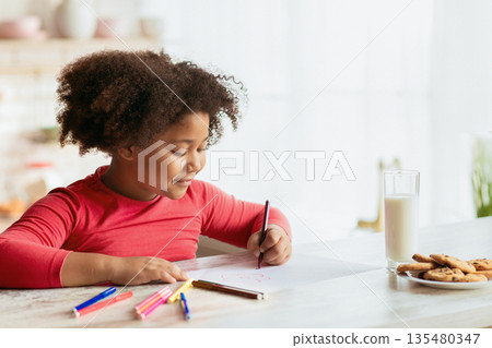 Kids Home Leisure. Cute Little Black Girl Drawing In Kitchen, Pretty African American Child Painting With Colorful Pencils, Sitting At Table With Cookies And Milk, Closeup Shot With Copy Space 135480347