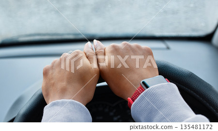 Modern woman driver and searching road by gps map. Hands of young african american lady with smart watch on steering in car with smartphone with empty screen in rainy weather, pov, free space, cropped Modern woman driver and searching road by gps map. Hands of young african american lady with smart watch on steering in car with smartphone with empty screen in rainy weather, pov, free space, cropped 135481172
