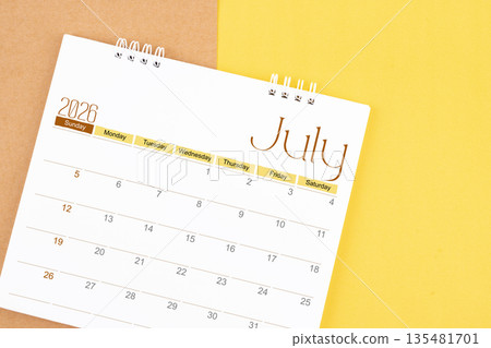 July 2026 desk calendar on brown and yellow, Planning for business. 135481701