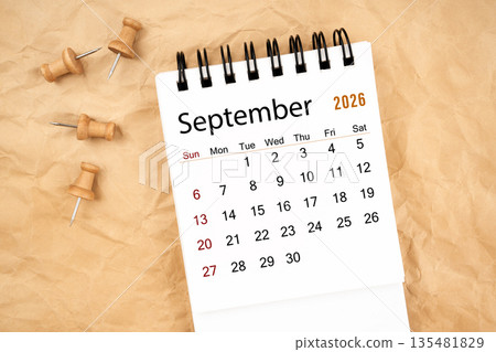 September 2026 white desk calendar with wooden thumbtack on old crumpled paper. September 2026 white desk calendar with wooden thumbtack on old crumpled paper. 135481829